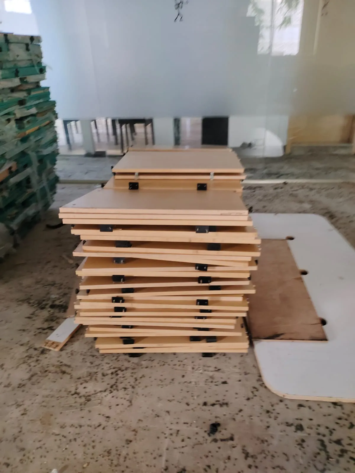 Disassembled corporate workspace desks stored flat-packed during an office furniture dismantling Siruseri project run.